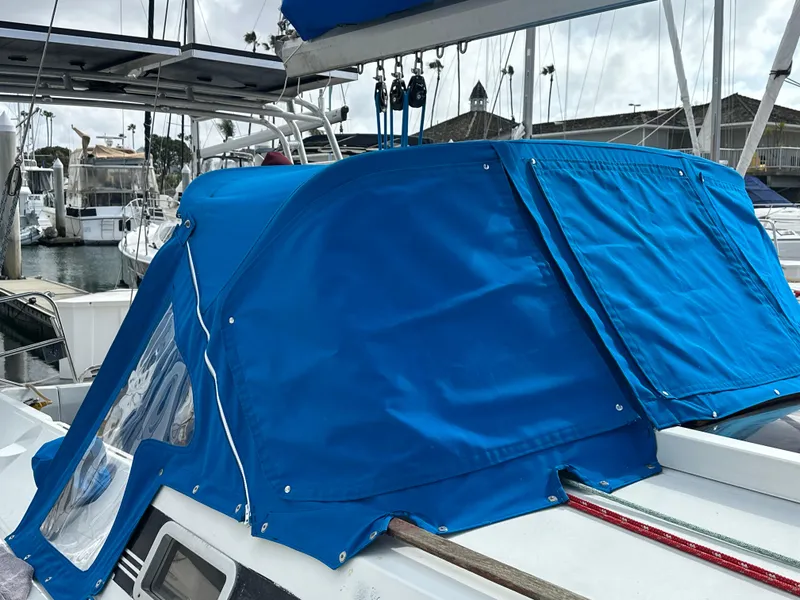 Slide: The Image of Blue canvas cover on 1986 Beneteau First 375 sailboat, docked in marina. - 26
