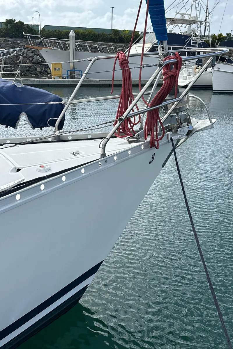 Slide: The Image of Beneteau First 375 sailboat, 1986 model, docked in a marina with red ropes. - 27