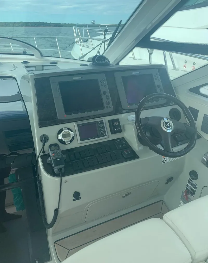 Slide: The Image of 2009 Sea Ray 470 Sundancer helm with navigation equipment and steering wheel. - 10