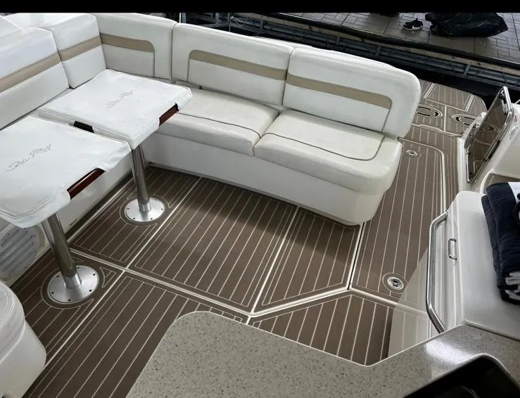 Slide: The Image of Luxurious interior of 2009 Sea Ray 470 Sundancer with white seating and wood-patterned flooring. - 15