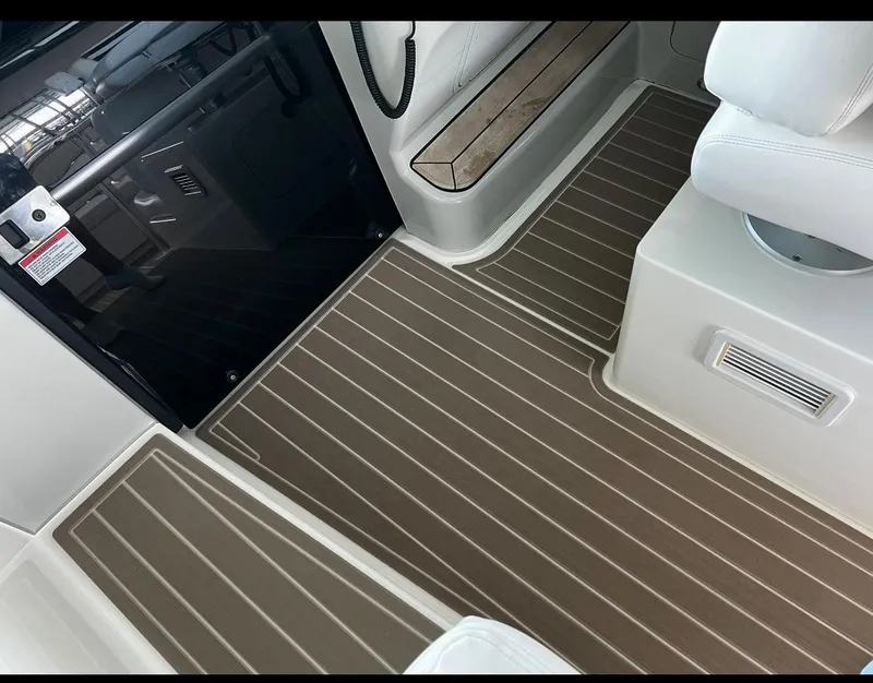 Slide: The Image of 2009 Sea Ray 470 Sundancer interior with striped flooring and seating area. - 16