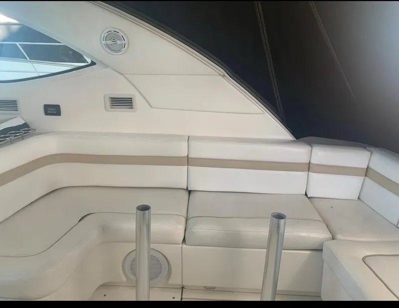 Slide: The Image of Interior seating of 2009 Sea Ray 470 Sundancer yacht, featuring white and beige upholstery. - 3