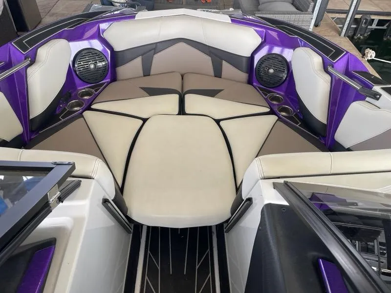 Slide: The Image of 2019 Centurion Fi25 boat interior with purple accents and seating area. - 10