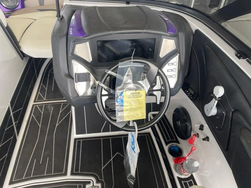 Slide: The Image of 2019 Centurion Fi25 boat dashboard with steering wheel and control panel. - 14
