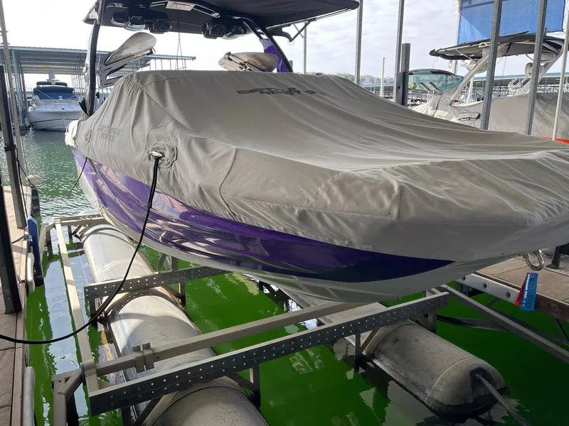 Slide: The Image of 2019 Centurion Fi25 boat covered and docked on a lift in a marina. - 5