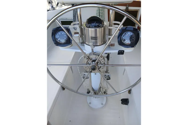 Slide: The Image of Steering wheel and gauges of a 1992 Valiant 40 sailboat cockpit. - 10