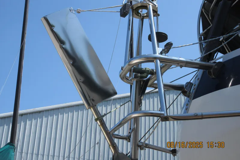 Slide: The Image of Close-up of a 1992 Valiant 40 sailboat's stainless steel wind vane against a clear sky. - 12