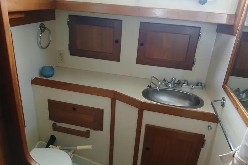 Slide: The Image of Valiant 40 yacht bathroom with wooden cabinets and stainless steel sink, 1992 model. - 13