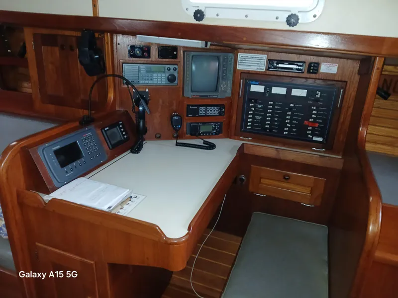 Slide: The Image of Navigation station inside a 1992 Valiant 40 yacht, featuring communication and control equipment. - 18