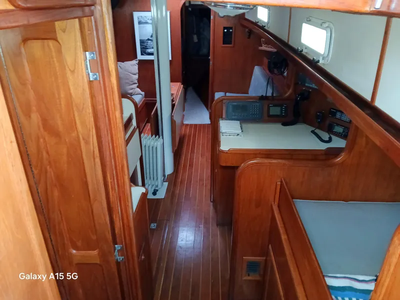 Slide: The Image of Interior of a 1992 Valiant 40 sailboat with wooden finishes and navigation equipment. - 19