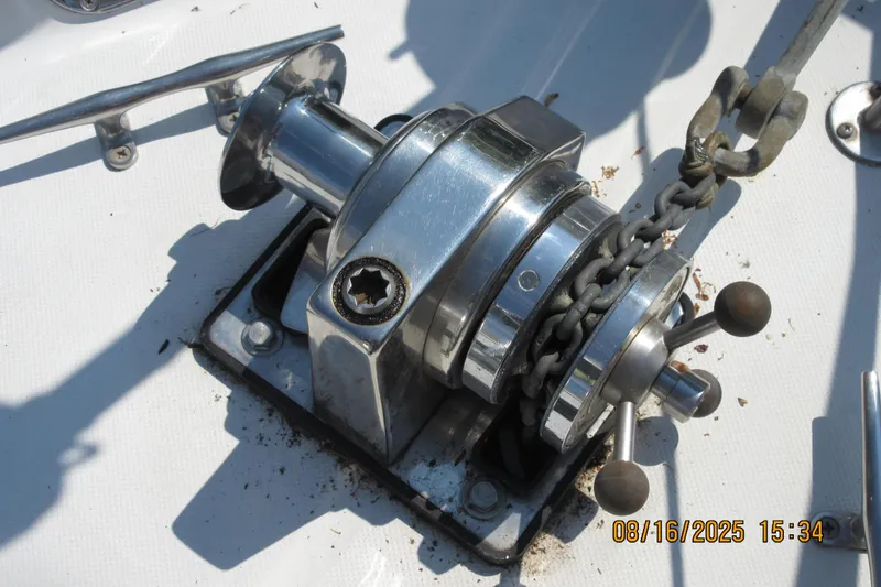 Slide: The Image of Chrome winch on 1992 Valiant 40 sailboat deck with chain and handle. - 9