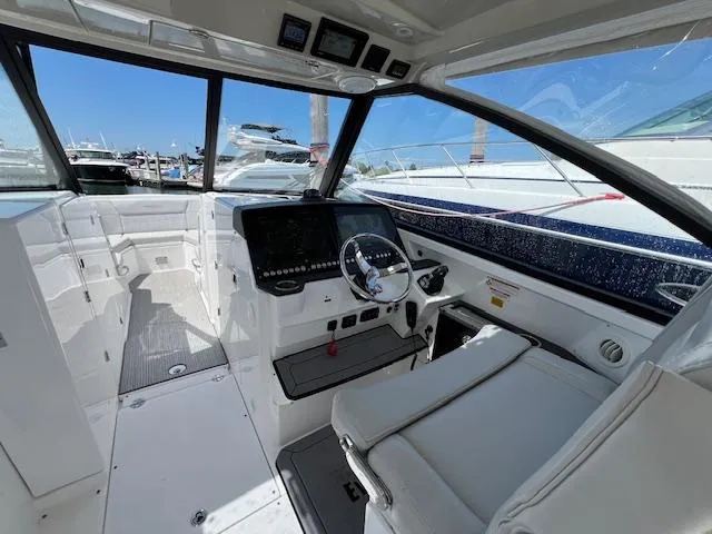 Slide: The Image of 2019 Everglades 340 Dual Console boat interior with modern dashboard and steering wheel. - 11