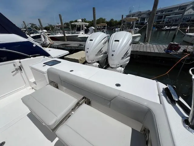 Slide: The Image of 2019 Everglades 340 Dual Console boat with twin outboard engines docked at marina. - 16