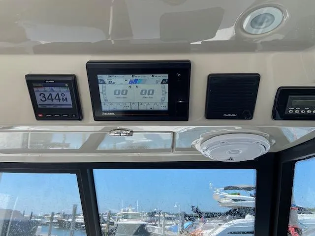 Slide: The Image of Control panel of 2019 Everglades 340 Dual Console boat with navigation displays. - 18