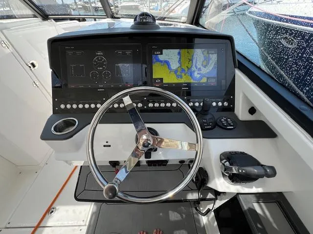 Slide: The Image of Cockpit of 2019 Everglades 340 Dual Console with navigation screens and steering wheel. - 7