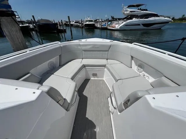 Slide: The Image of 2019 Everglades 340 Dual Console boat interior at marina, featuring spacious seating. - 8