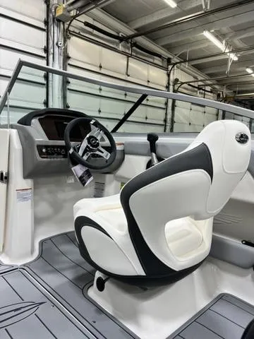 Slide: The Image of 2024 Chaparral 21 SSi boat interior with modern steering and seating. - 10