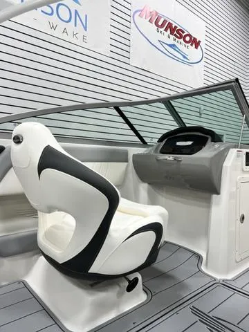 Slide: The Image of 2024 Chaparral 21 SSi boat interior with sleek captain's chair and modern dashboard. - 11