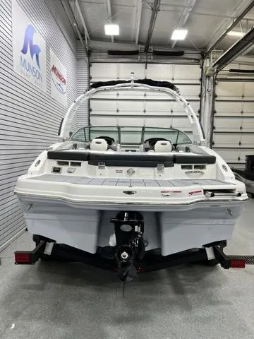 Slide: The Image of 2024 Chaparral 21 SSi boat in showroom, rear view, white interior, Munson signage. - 4