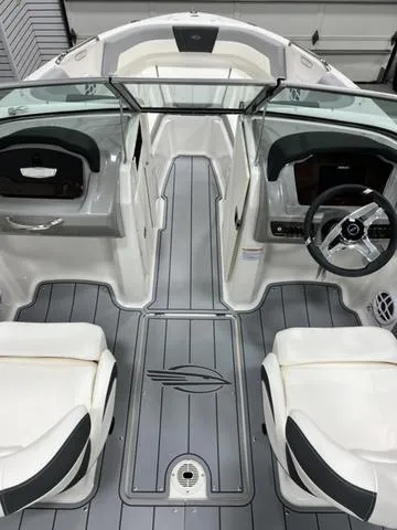 Slide: The Image of 2024 Chaparral 21 SSi boat interior with sleek seating and modern dashboard design. - 7