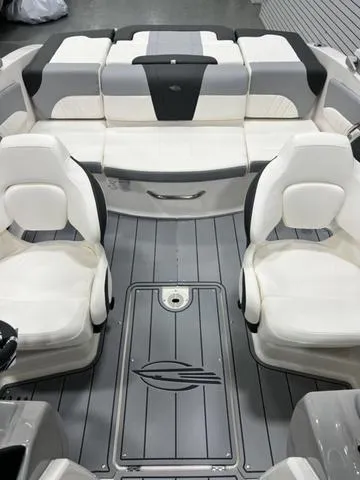 Slide: The Image of 2024 Chaparral 21 SSi boat interior with white and gray seating and flooring. - 9