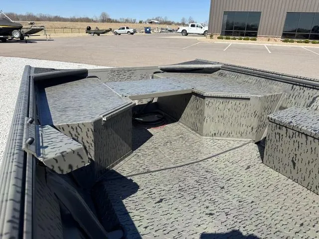 Slide: The Image of 2025 War Eagle 648 LDV boat on trailer, parked on gravel, clear sky background. - 10