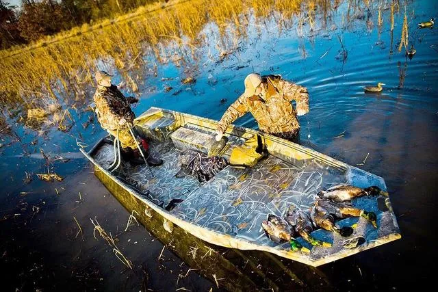 Slide: The Image of 2025 War Eagle 648 LDV boat interior with camouflage pattern, parked outdoors. - 15