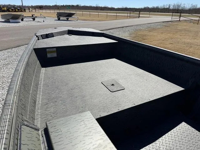 Slide: The Image of 2025 War Eagle 648 LDV 21" boat on trailer, displayed outdoors near a Yamaha billboard. - 6