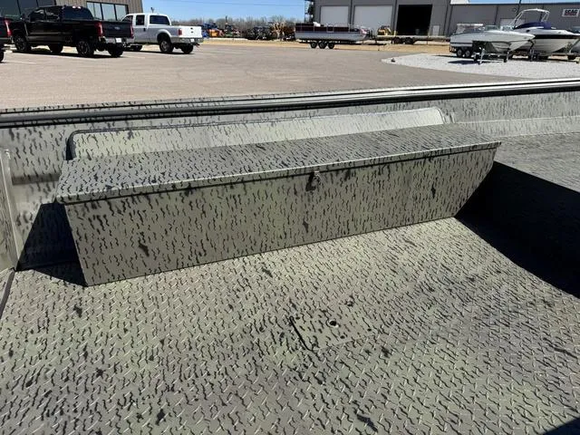 Slide: The Image of 2025 War Eagle 648 LDV 21" boat on trailer, parked on gravel lot. - 9