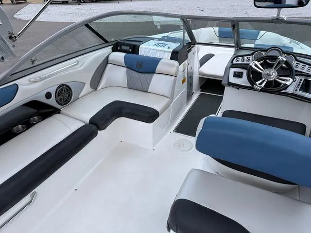 Slide: The Image of 2013 MasterCraft X45 boat interior with blue and white seating and modern dashboard. - 12