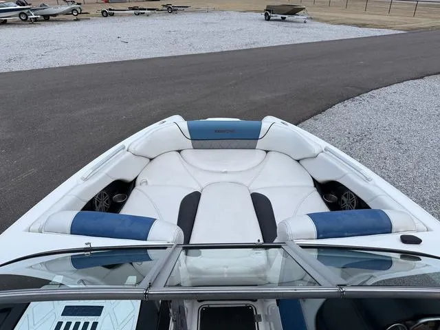 Slide: The Image of 2013 MasterCraft X45 boat interior with white and blue seating. - 14