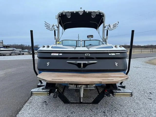 Slide: The Image of 2013 MasterCraft X45 boat with wakeboard tower, parked on gravel. - 5