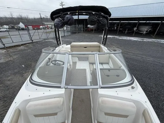 Slide: The Image of 2014 Regal 1900 ES boat with open bow and seating, parked outdoors. - 11