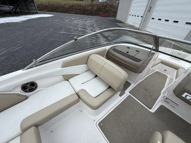 Slide: The Image of 2014 Regal 1900 ES boat interior with beige seating and carpeted flooring. - 15