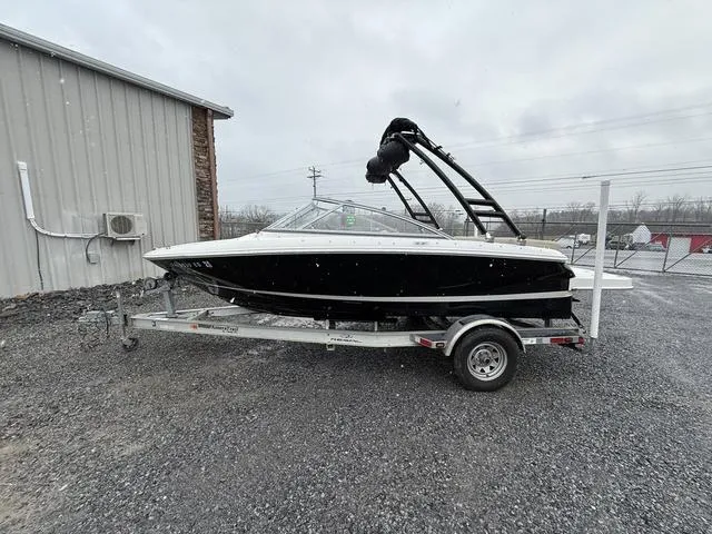 Slide: The Image of 2014 Regal 1900 ES boat on trailer, parked outdoors on gravel. - 3