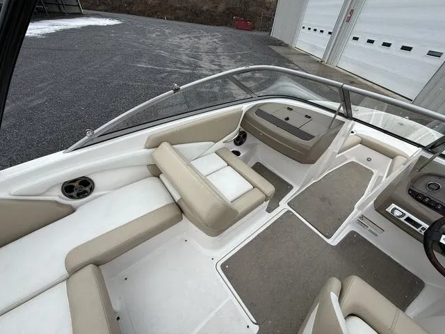 Slide: The Image of 2014 Regal 1900 ES boat interior with beige seating and carpeted flooring. - 5