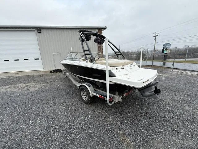 Slide: The Image of 2014 Regal 1900 ES boat on trailer, parked outside a warehouse. - 6