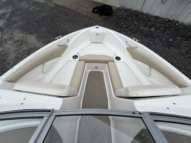 Slide: The Image of 2014 Regal 1900 ES boat interior with beige seating and cup holders. - 9