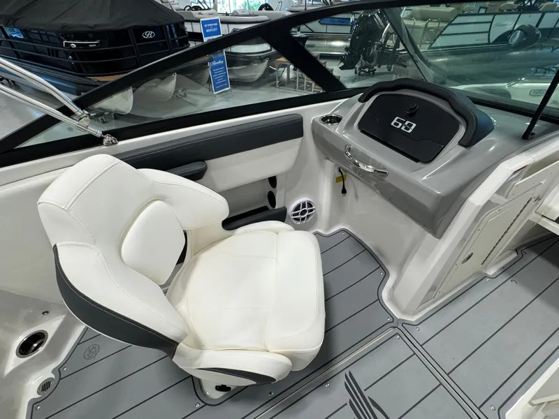 Slide: The Image of 2025 Chaparral 21 SSi Ski & Fish boat interior with white seating and dashboard. - 11