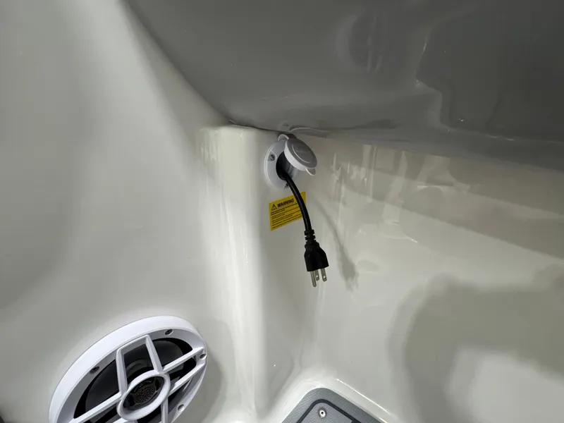 Slide: The Image of 2025 Chaparral 21 SSi Ski & Fish boat interior with speaker and power outlet. - 13