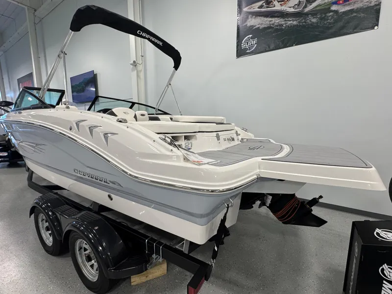 Slide: The Image of 2025 Chaparral 21 SSi Ski & Fish boat on trailer in showroom. - 3