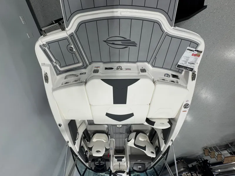 Slide: The Image of 2025 Chaparral 21 SSi Ski & Fish boat interior, featuring seating and storage compartments. - 4