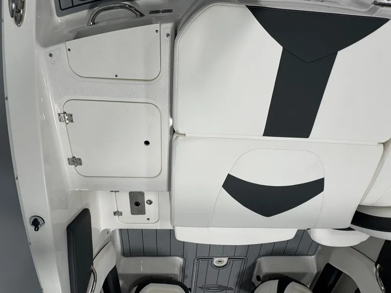 Slide: The Image of 2025 Chaparral 21 SSi Ski & Fish boat interior with white and black seating. - 6