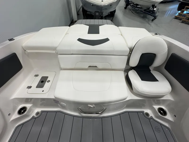 Slide: The Image of 2025 Chaparral 21 SSi Ski & Fish boat interior with white seating and gray flooring. - 7