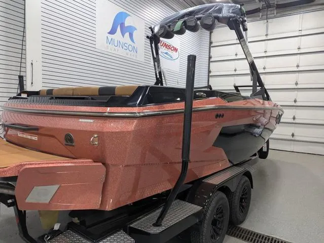 Slide: The Image of 2025 Axis Wake Research A225 boat in showroom, featuring sleek design and vibrant color. - 12