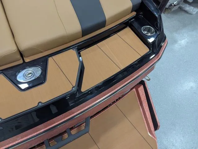 Slide: The Image of 2025 Axis Wake Research A225 boat interior with tan and black seating. - 14