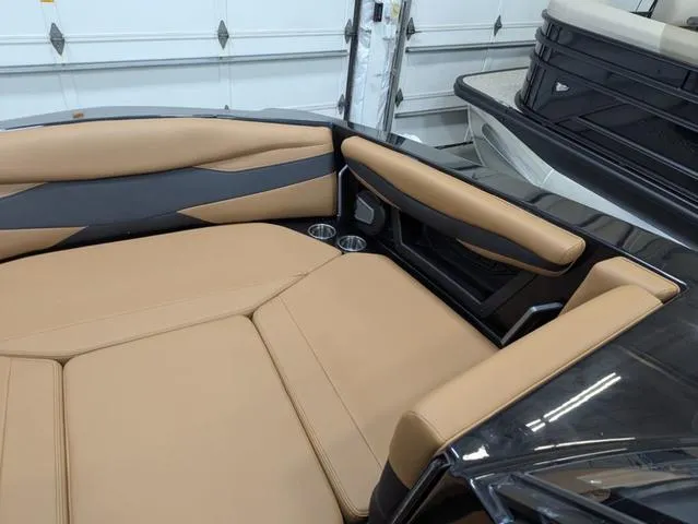 Slide: The Image of 2025 Axis Wake Research A225 boat interior with tan and black seating. - 16