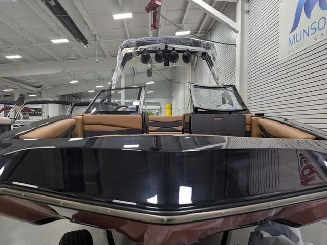 Slide: The Image of 2025 Axis Wake Research A225 boat in showroom, featuring sleek design and spacious seating. - 3