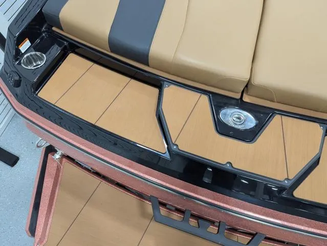 Slide: The Image of 2025 Axis Wake Research A225 boat interior with tan and black seating. - 5