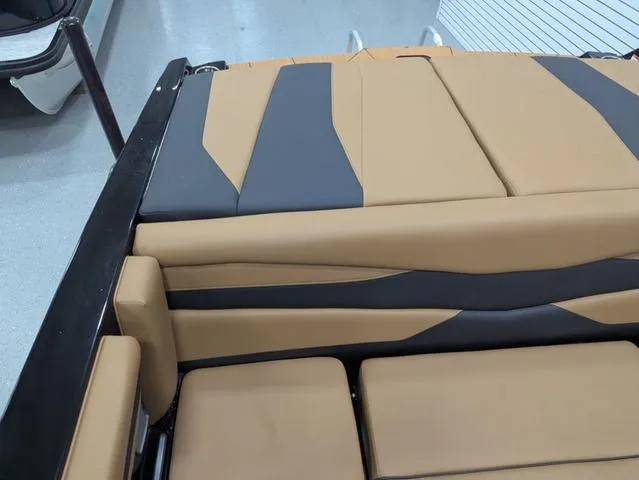 Slide: The Image of 2025 Axis Wake Research A225 boat interior with tan and gray upholstery. - 8